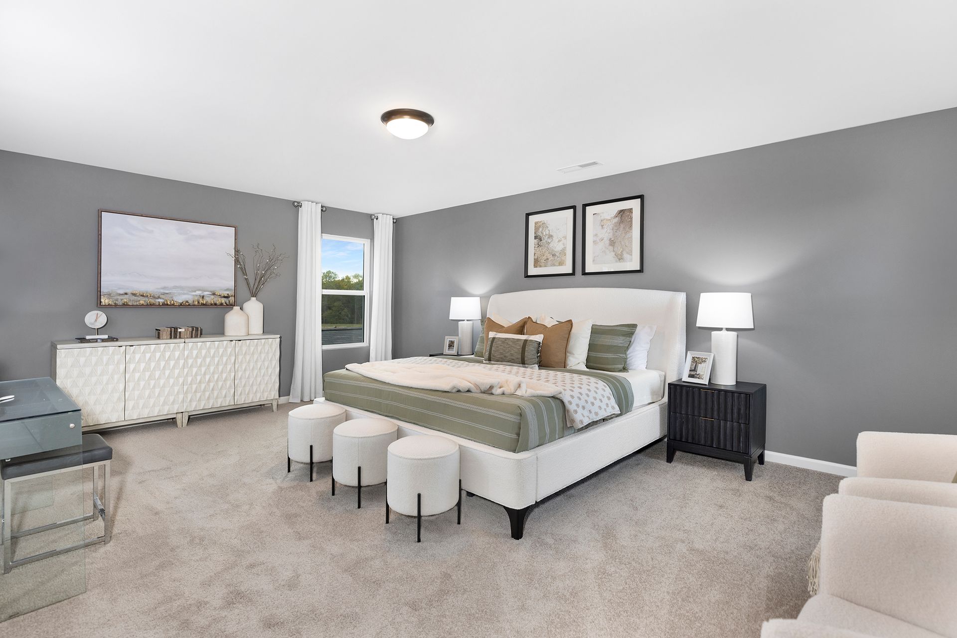 A bedroom with a large bed and a television on the wall.