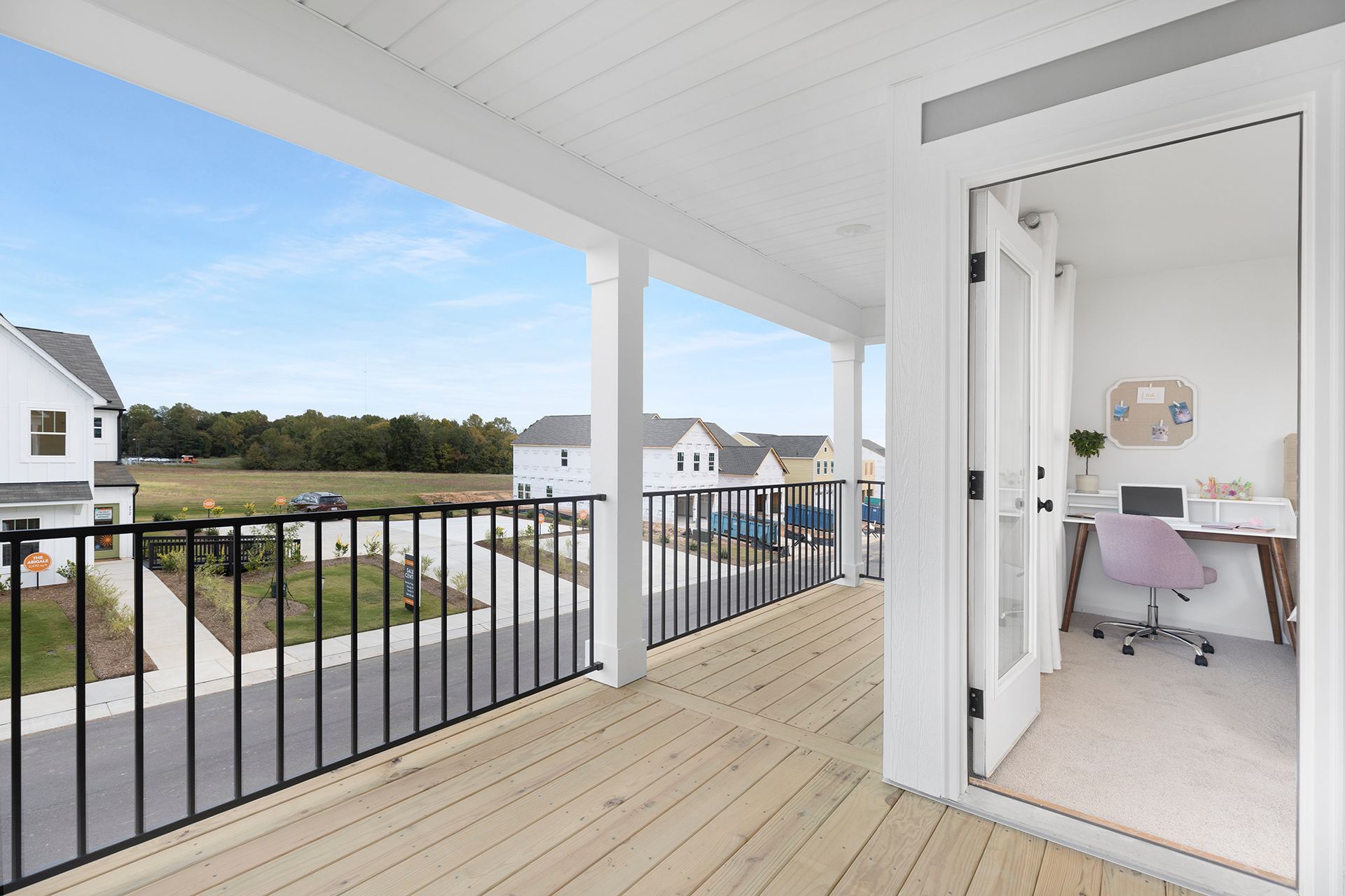 A balcony with a desk and chair on it