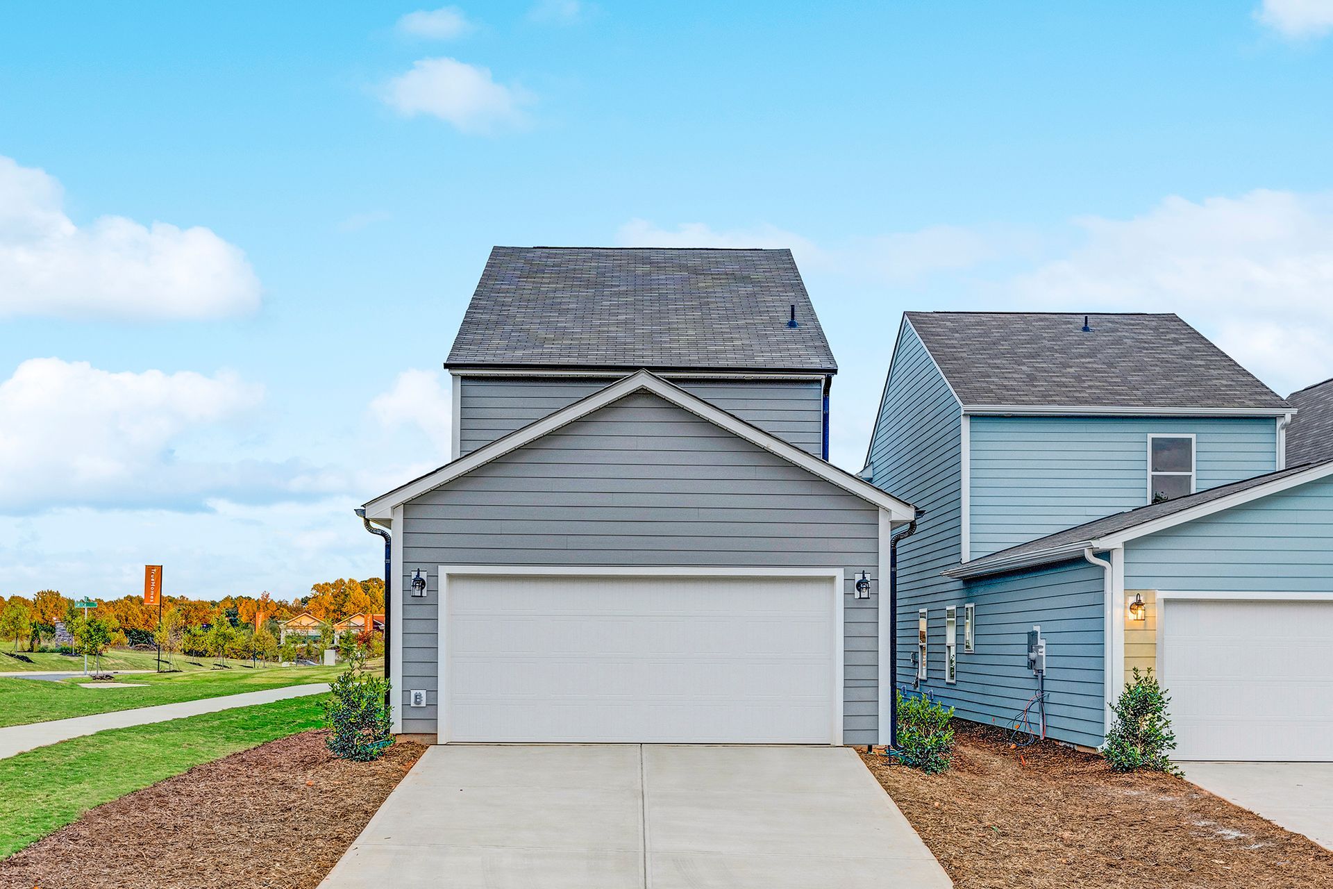 The front of a house with two garages and a driveway.