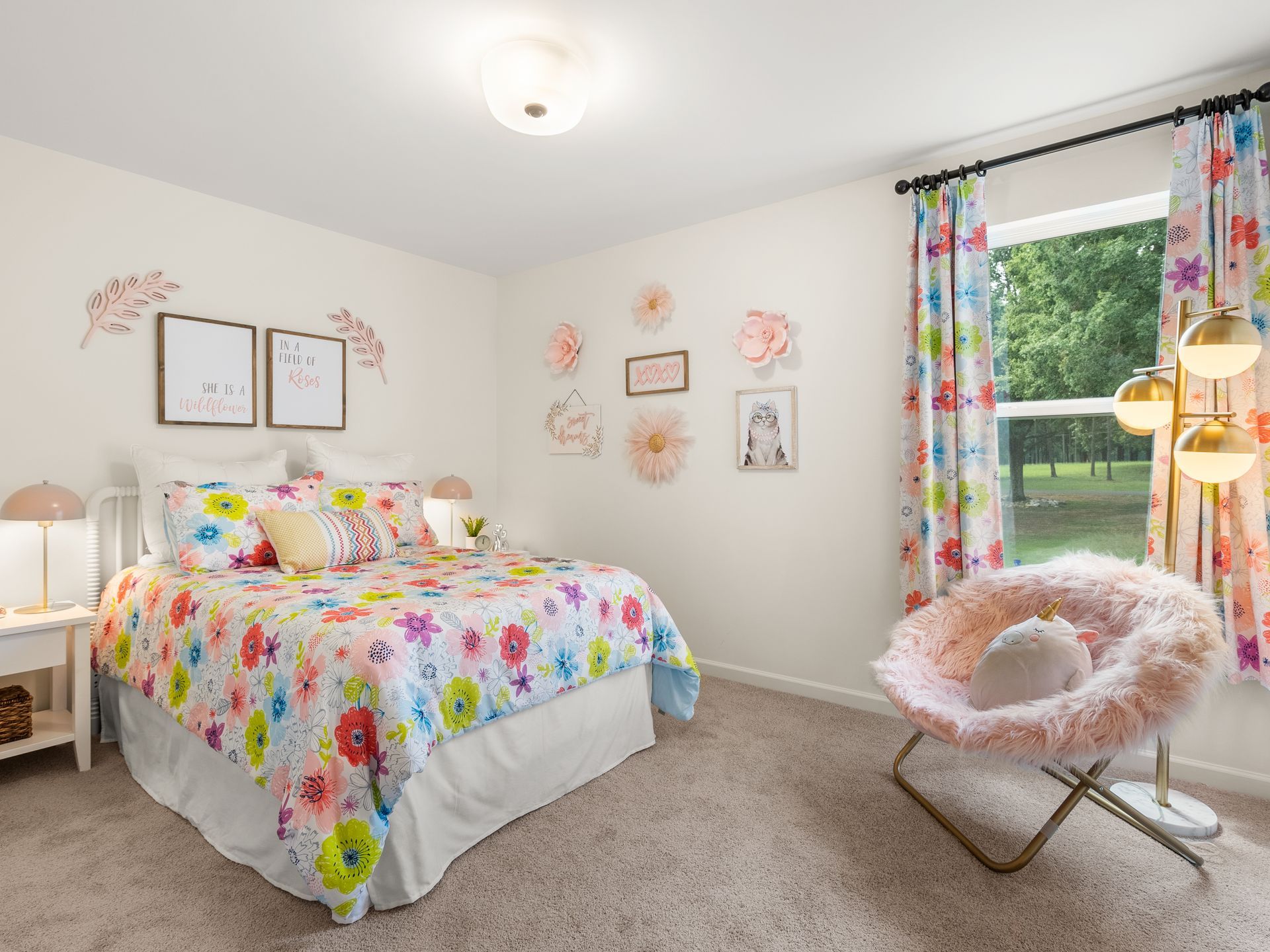 A bedroom with a bed , chair , lamp and window.
