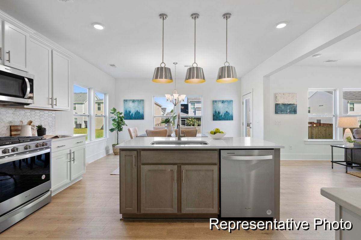 A kitchen with a large island and stainless steel appliances.