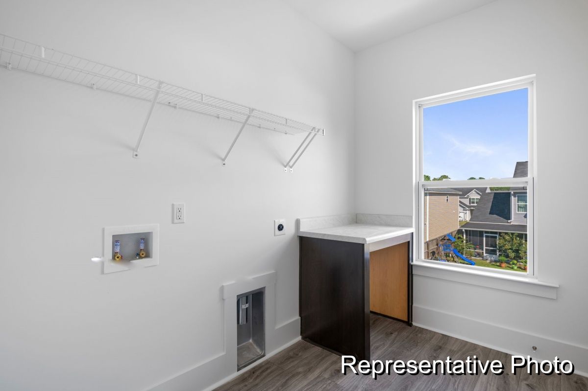 A laundry room with a washer and dryer and a window.