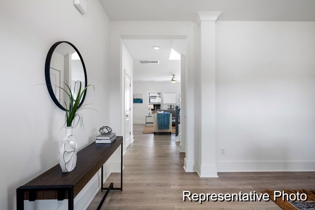 A representative photo of a hallway with a table and a mirror.