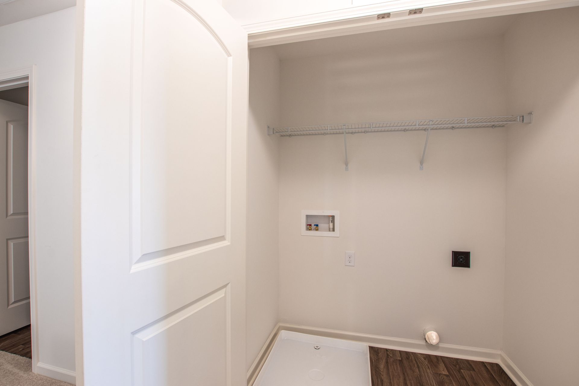 A laundry room in a house with a washer and dryer.