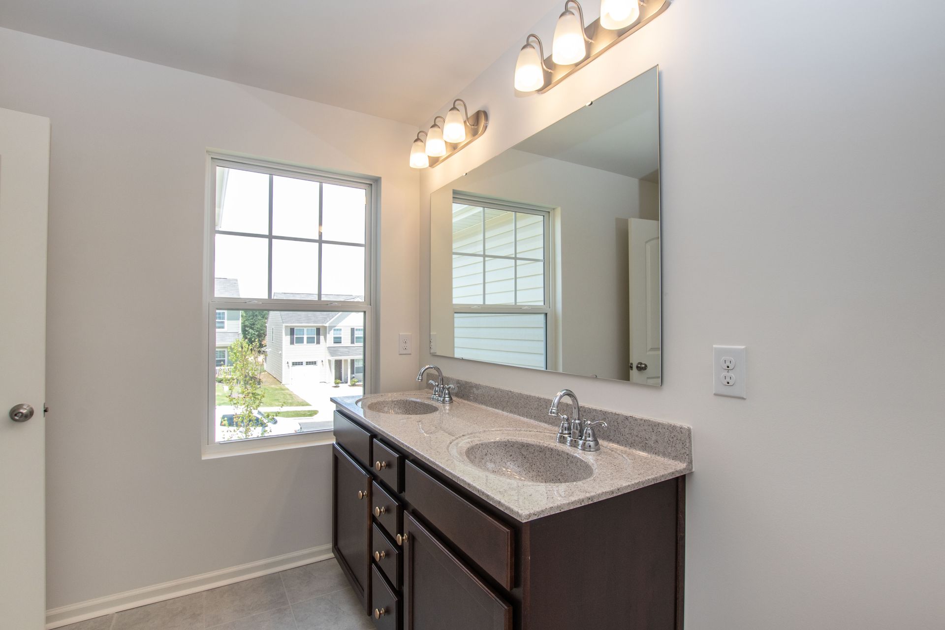 A bathroom with two sinks and a large mirror.
