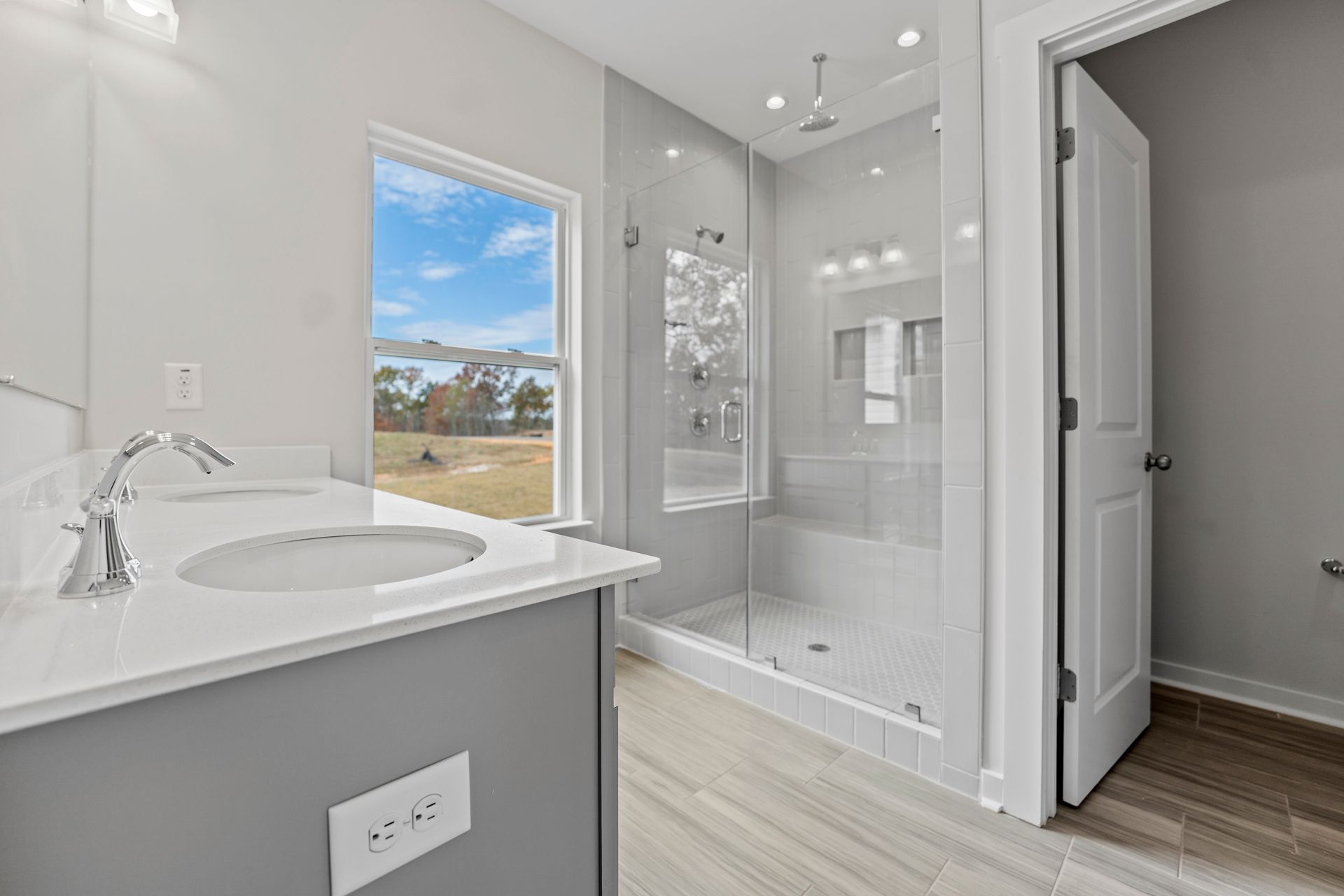A bathroom with a sink and a walk in shower.