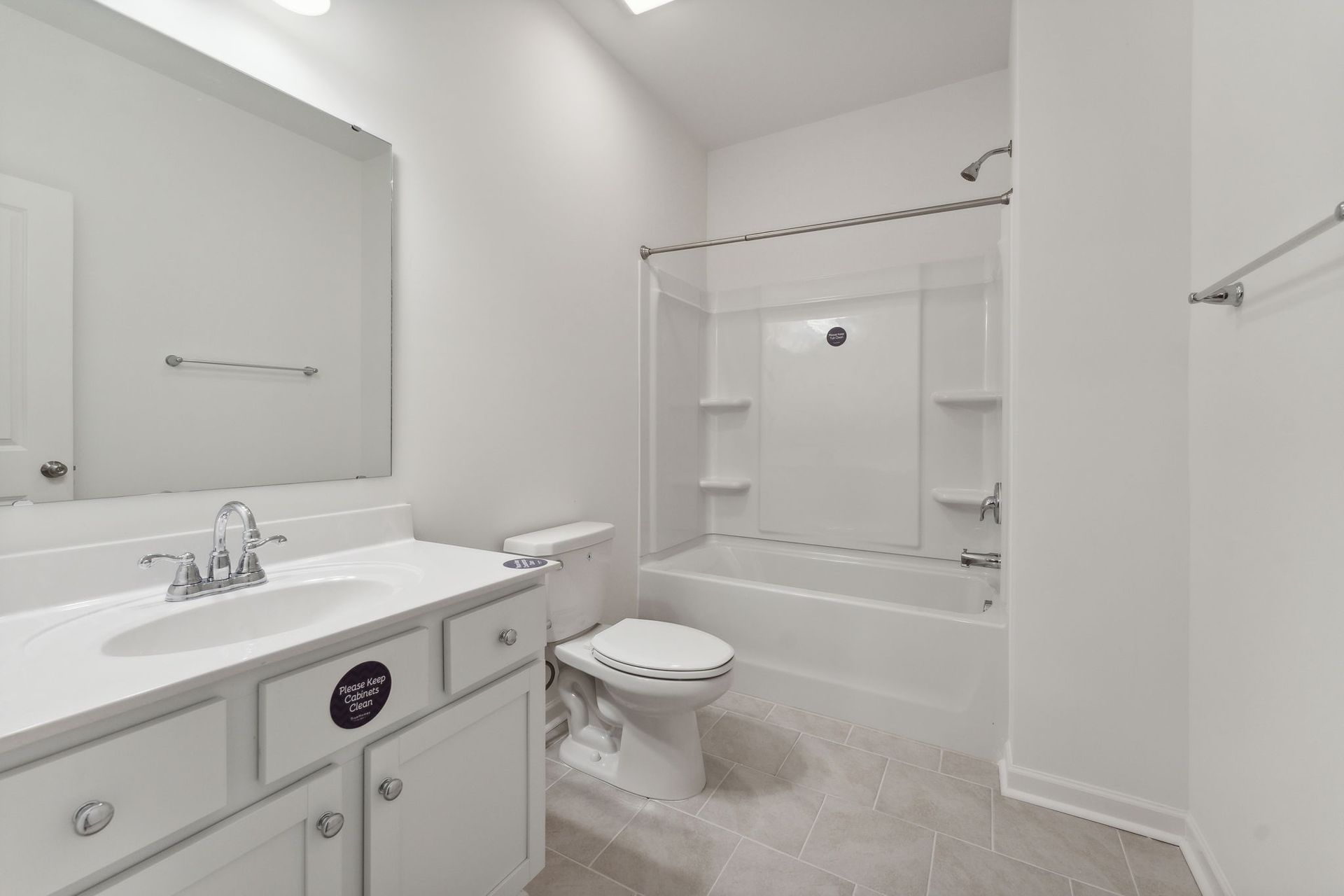 A bathroom with a sink , toilet , bathtub and mirror.