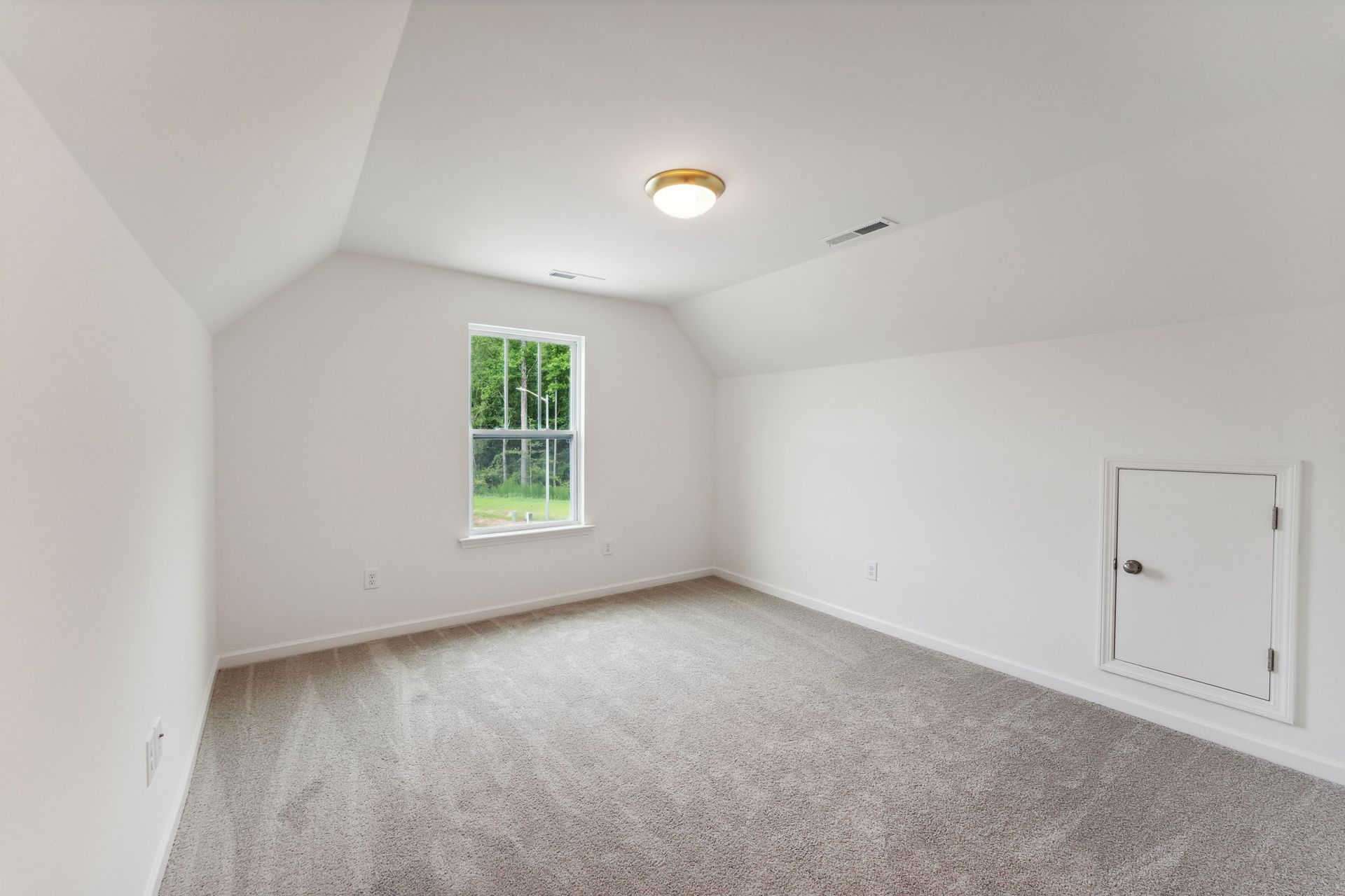 An empty room with a window and a ceiling fan.