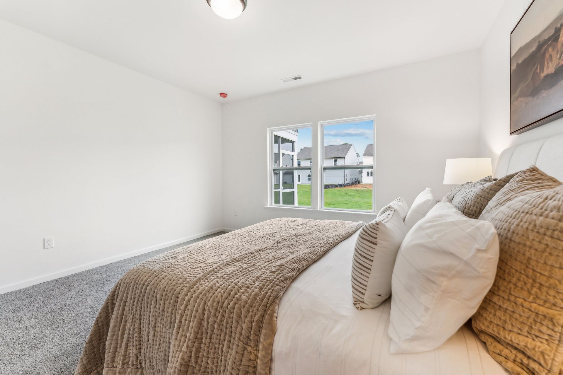 A bedroom with a large bed and a window.