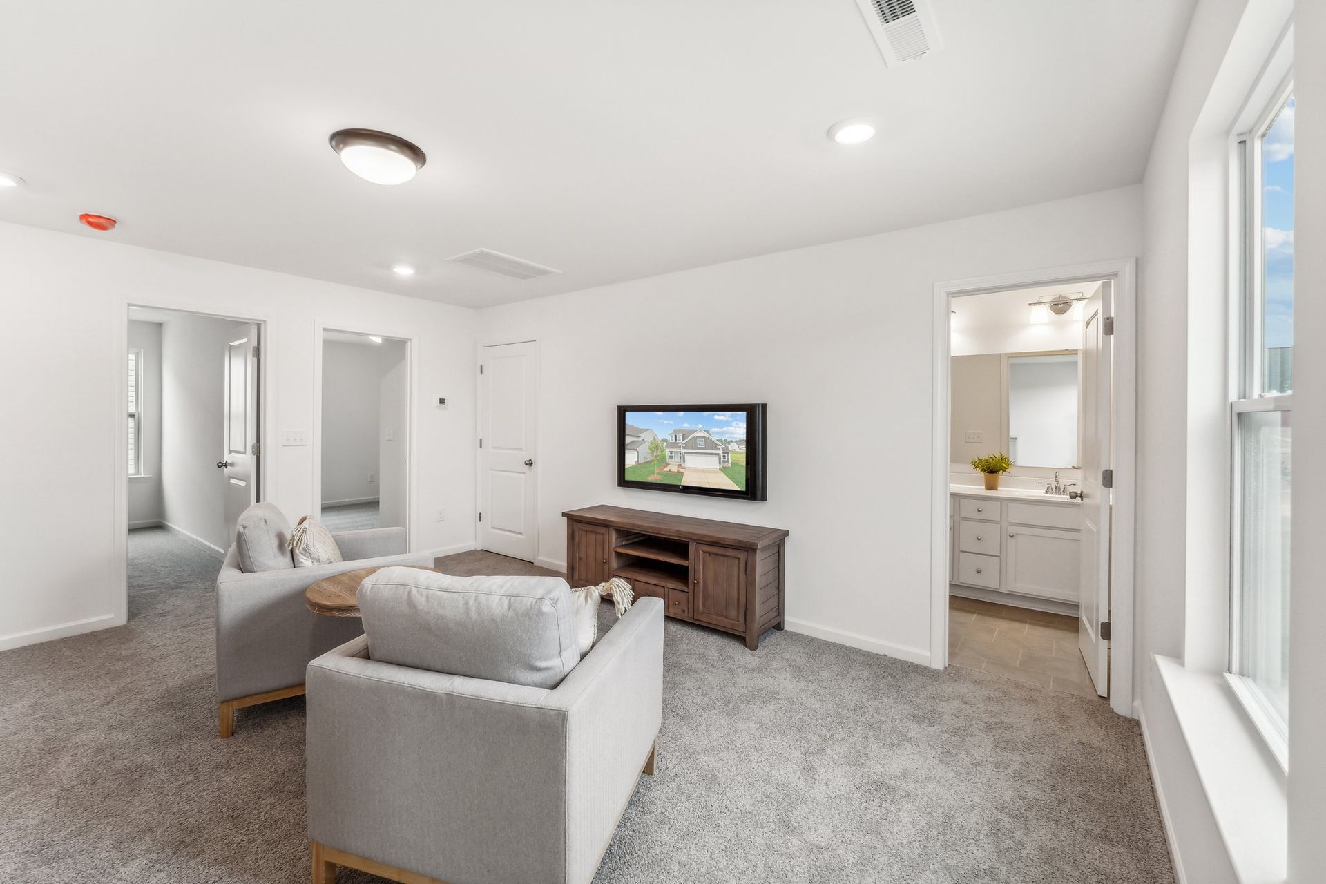 A living room with a couch , chair , and television.