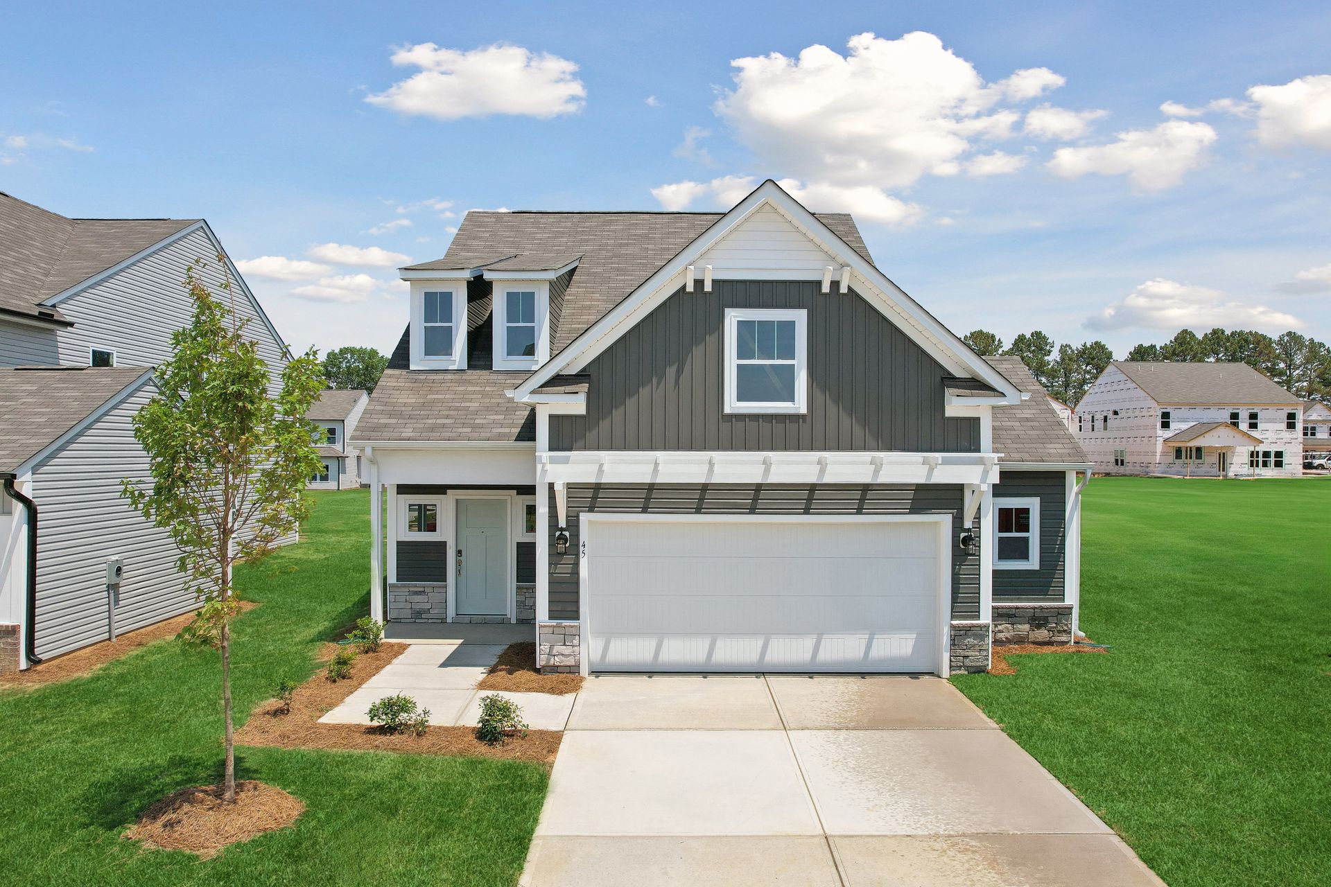 A house with a large garage and a driveway in a residential area.