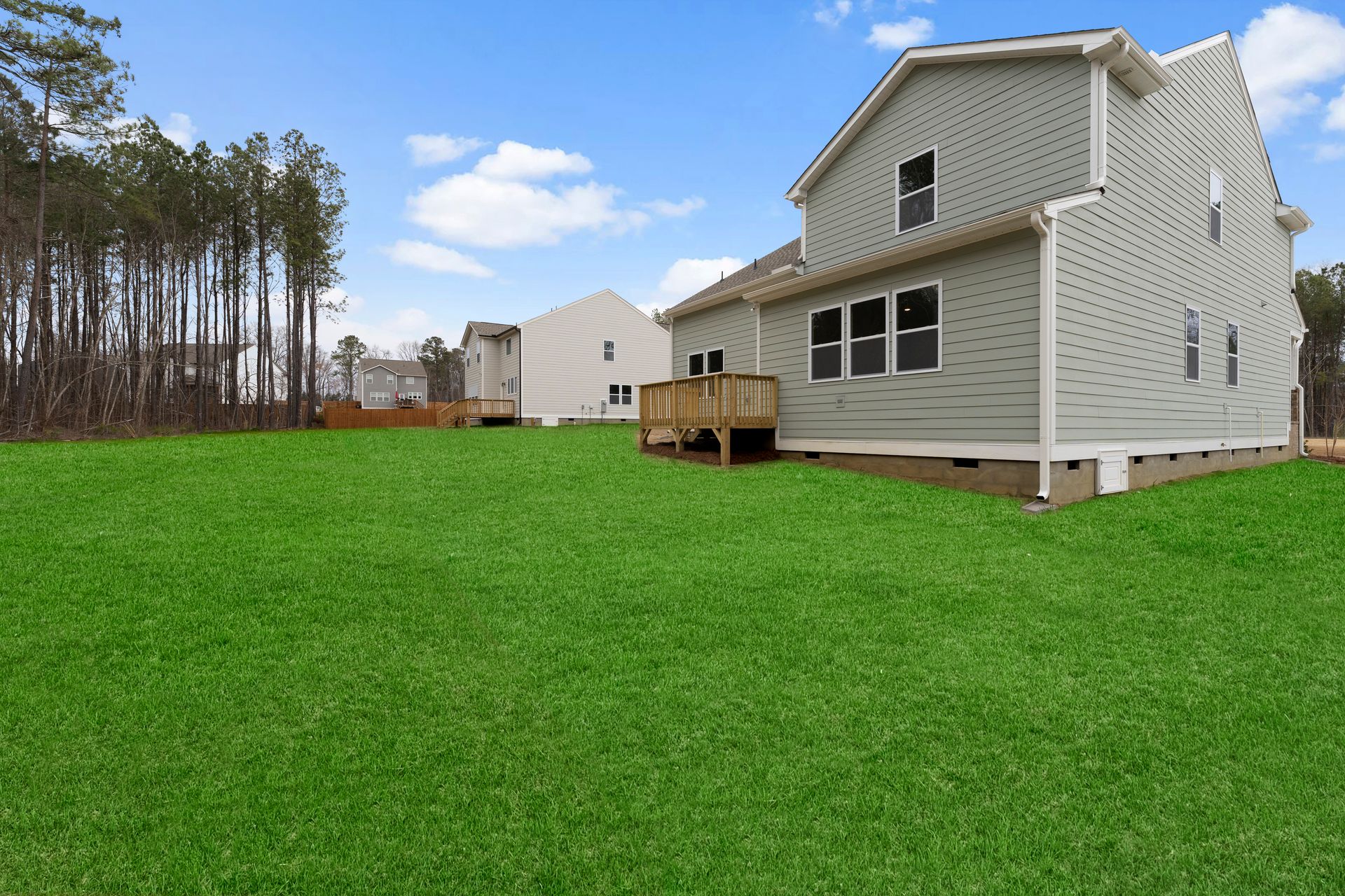 A house with a large lawn in front of it.