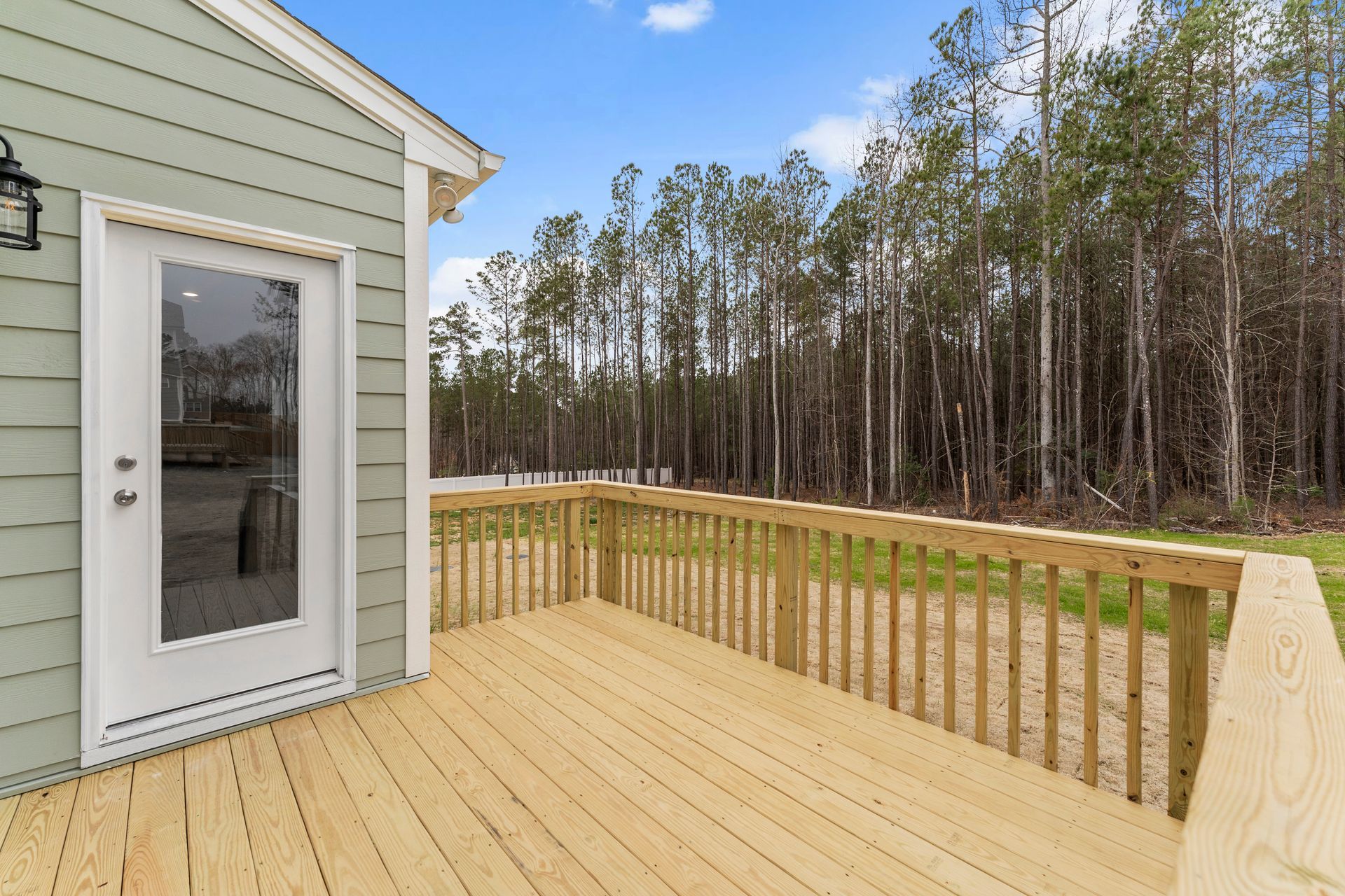 A house with a wooden deck and a sliding glass door.
