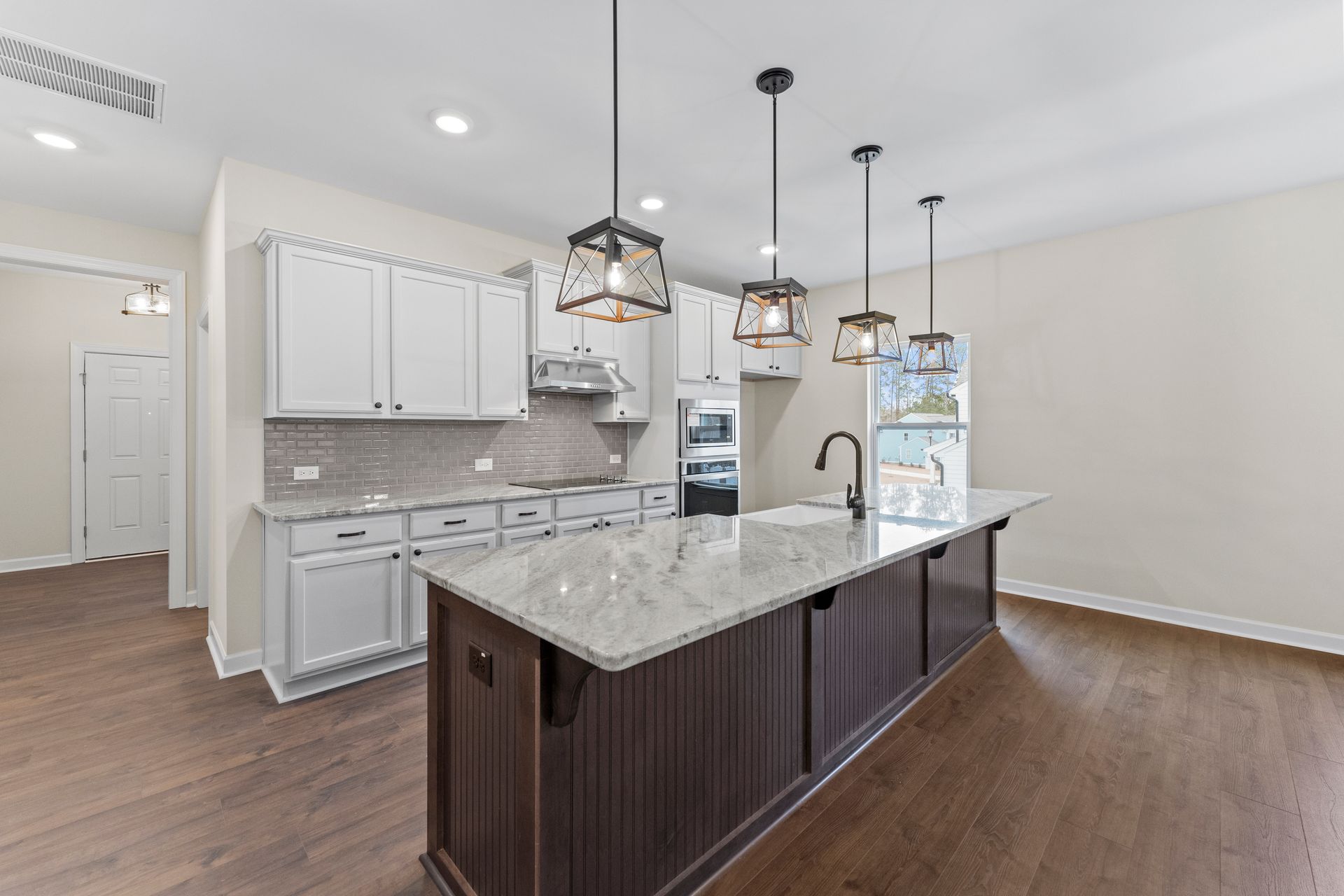 There is a large island in the middle of the kitchen.