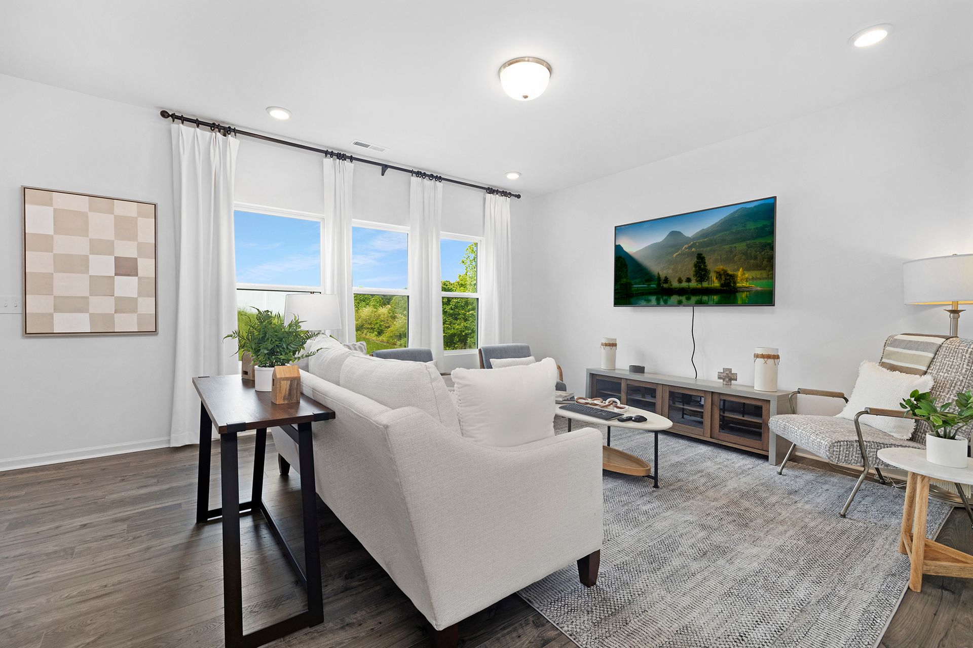A living room with a couch , chairs , and a coffee table.