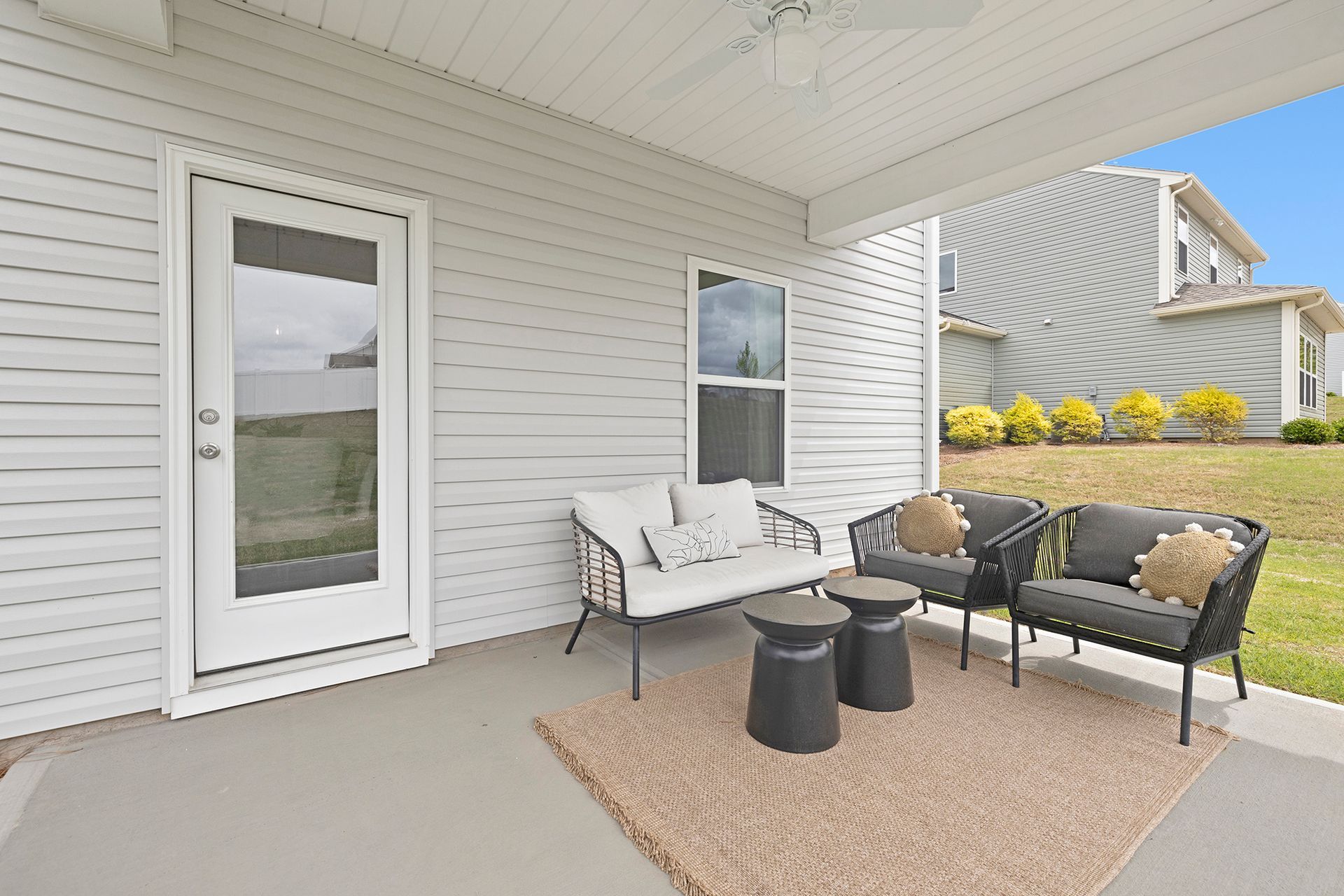 There is a patio with a couch and chairs on it.