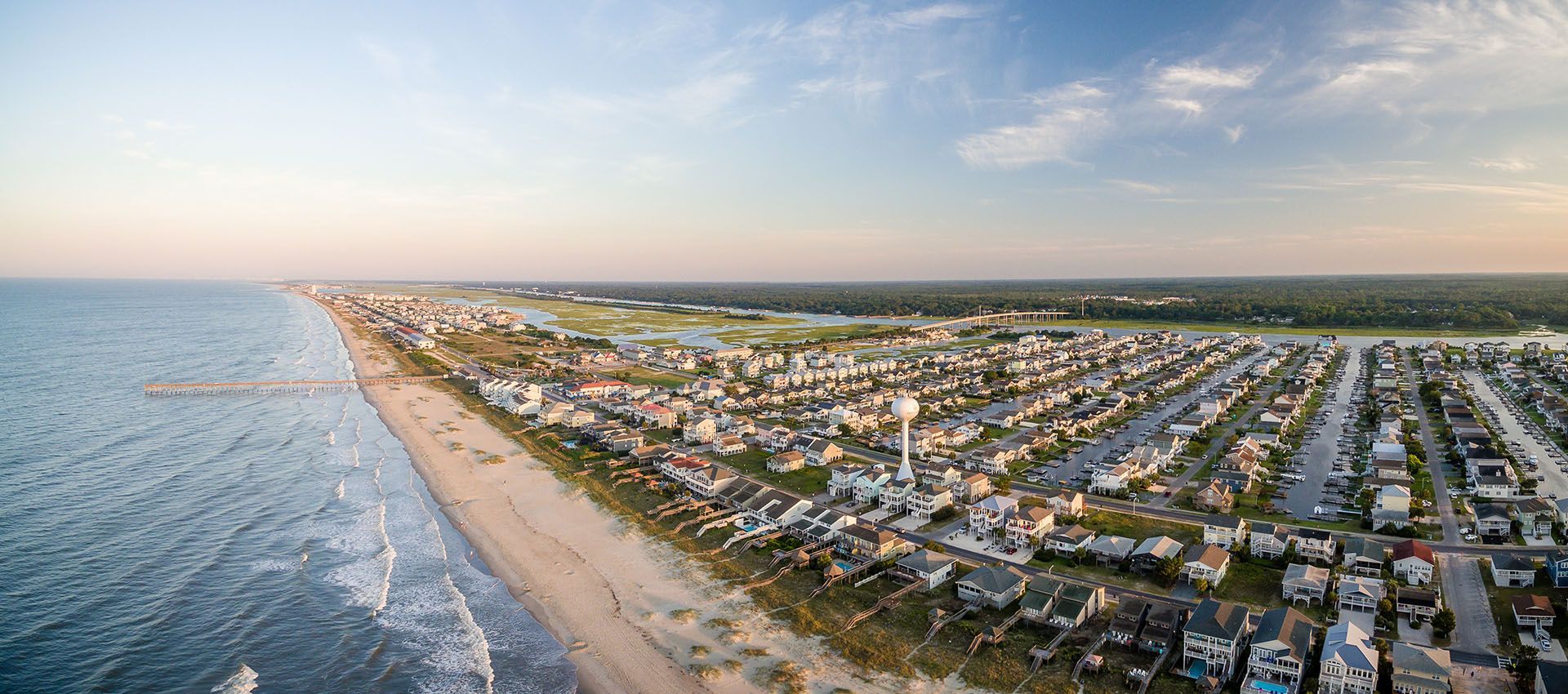 An aerial view of a city next to the ocean.