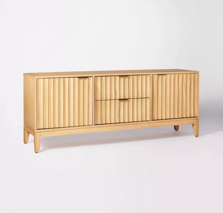 A wooden cabinet with drawers and doors on a white background.