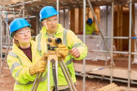 a man and a woman are working on a construction site .