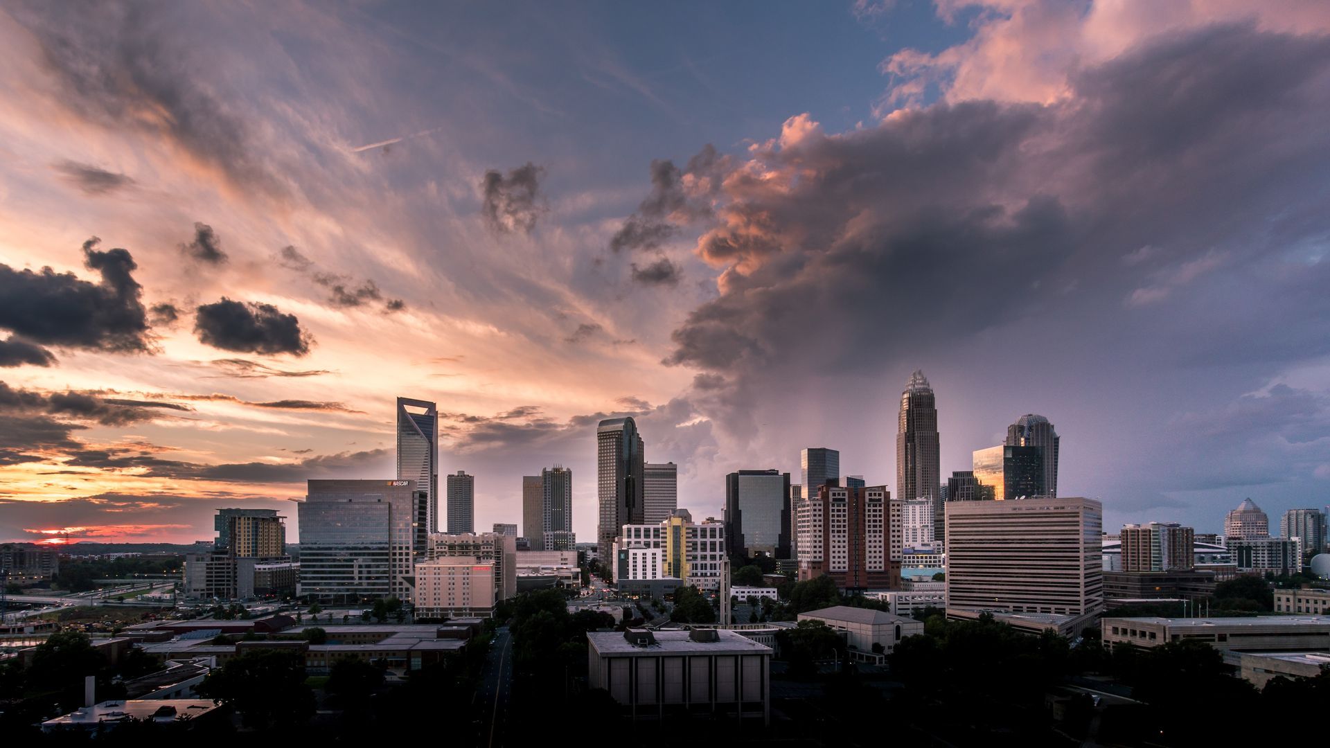 An aerial view of a city skyline at sunset.