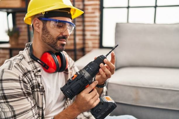 Handyman smiling while holding a tool belt, representing Trend Building Services' commercial handyma