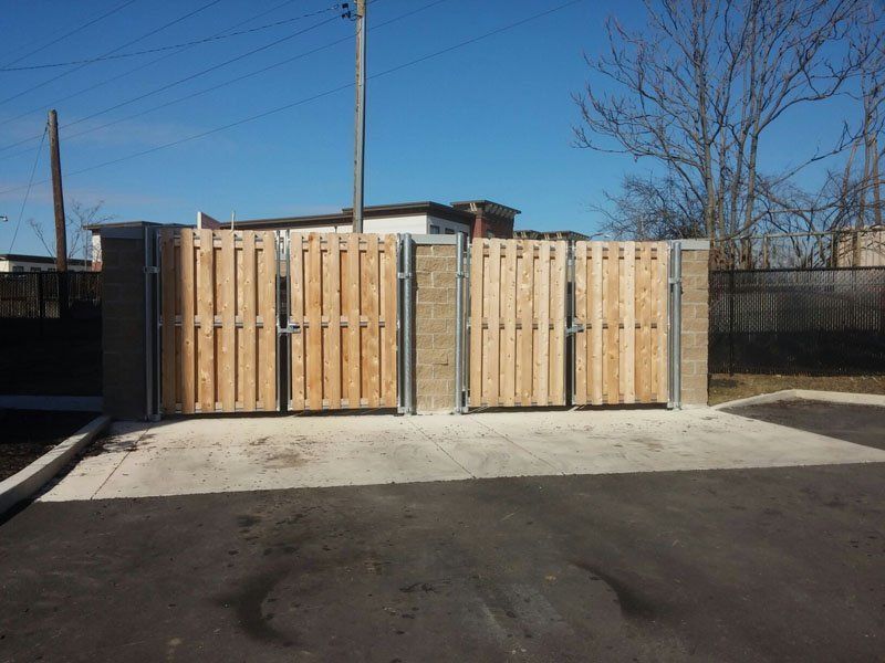 Wooden trash enclosure with concrete base