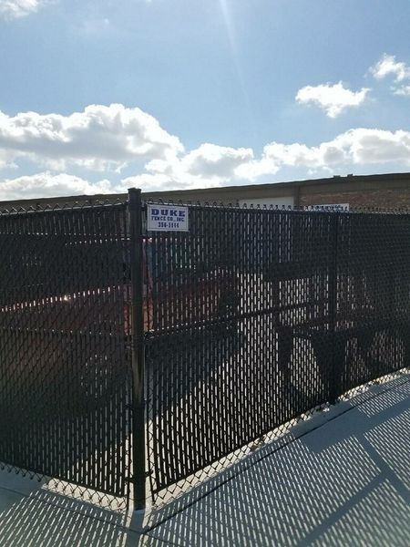 Black chain-link fence with a sign