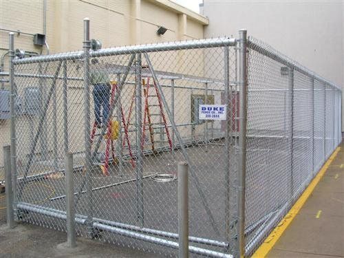 Chain-link fence encloses machinery