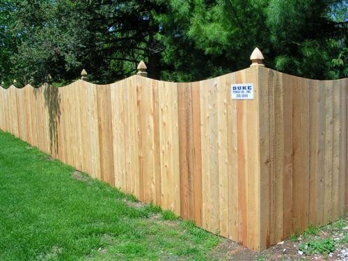Wooden fence with curved top and finials