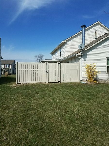 White fence enclosing a grassy backyard