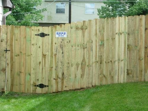 Wooden fence with gate in a yard
