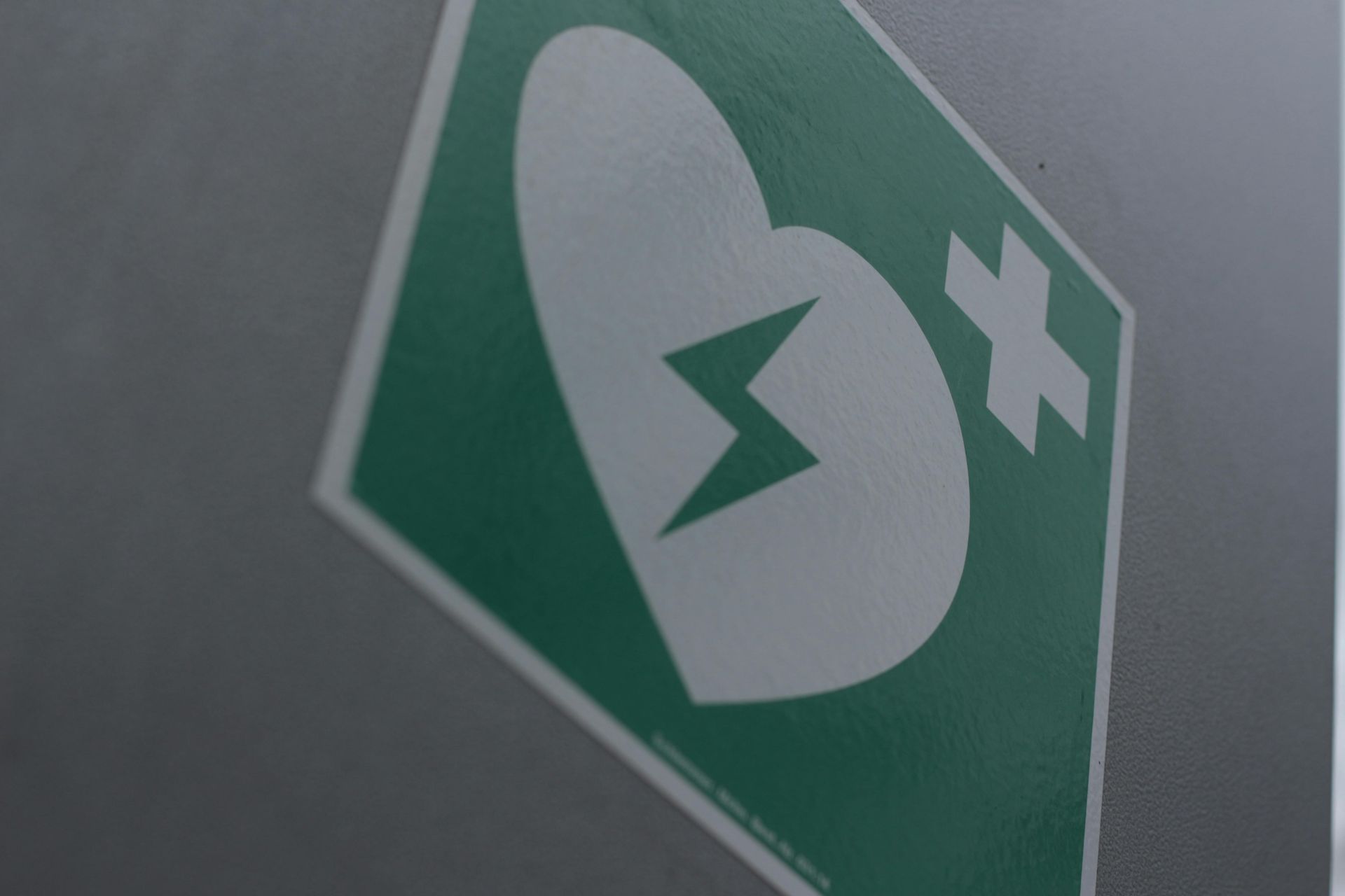A green sign with a heart and a lightning bolt on it.
