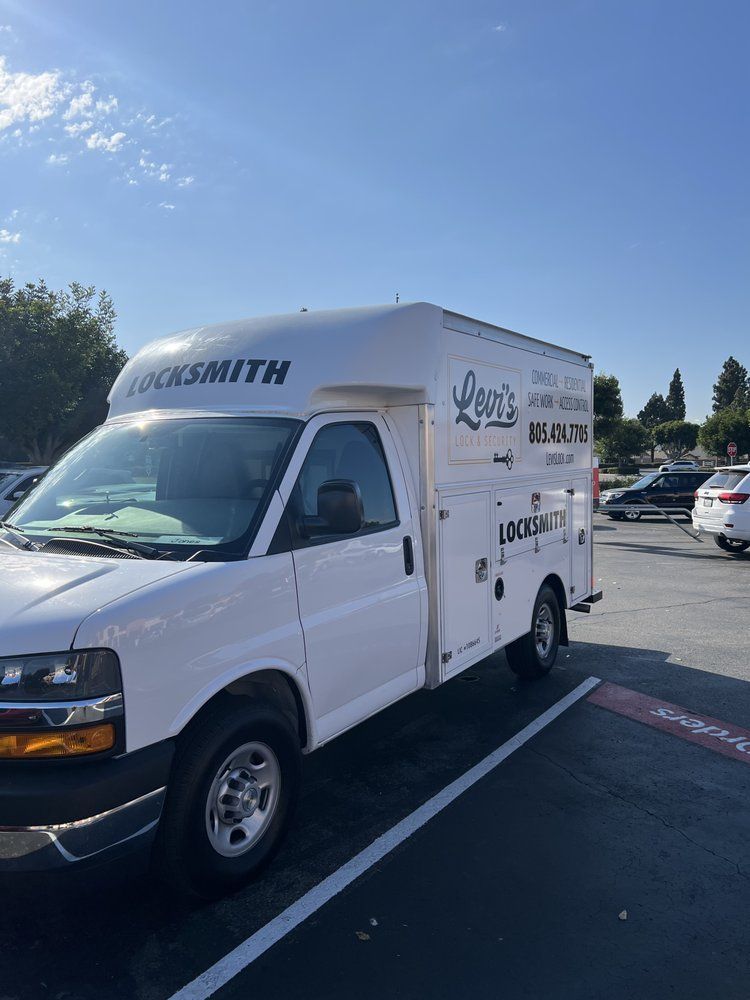 A white van is parked in a parking lot.