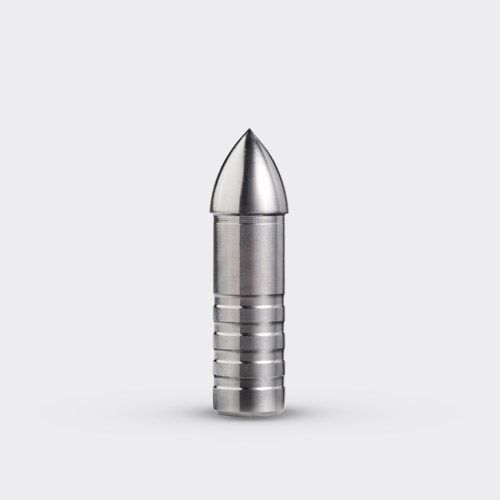 A stainless steel arrow point is sitting on a white surface.