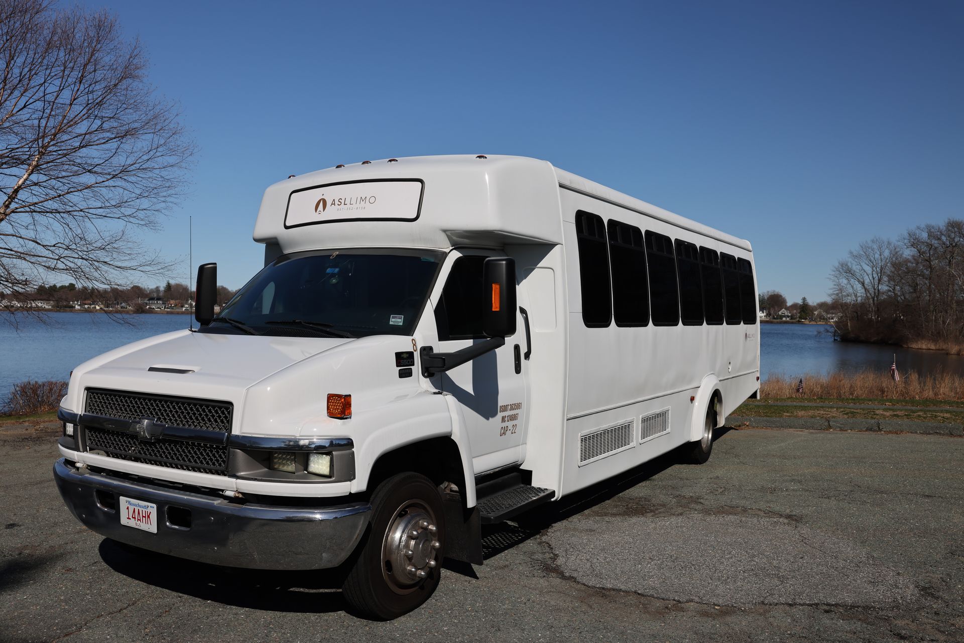 a black sprinter van is parked in a parking lot in front of a building .