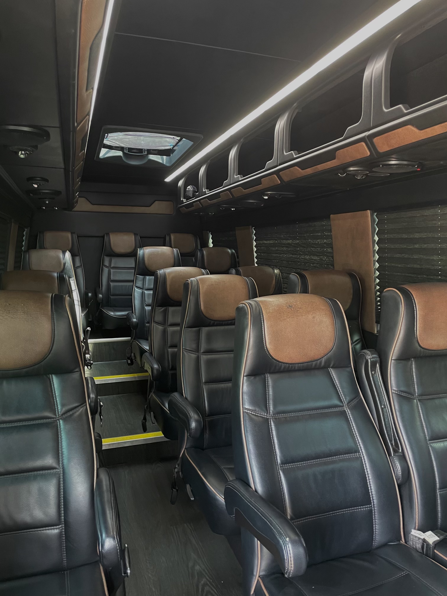 the inside of a sprinter with many leather seats