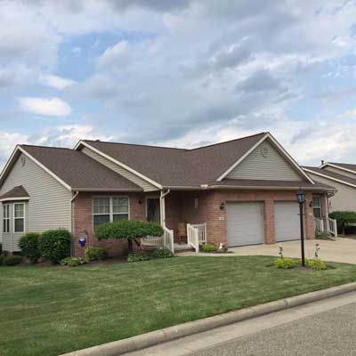 A Brick House With A Brown Roof — Akron, OH — D&M Roofing LLC