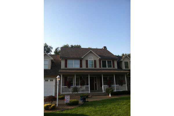 A Large House With A Porch — Akron, OH — D&M Roofing LLC