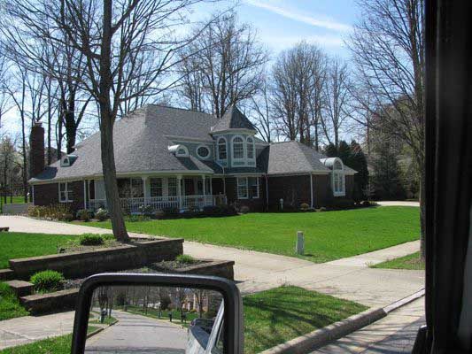 A View Of A House From A Car Window — Akron, OH — D&M Roofing LLC