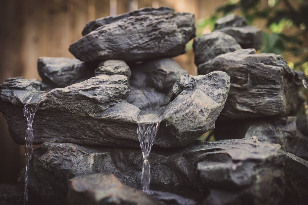 Rock fountain with water cascading down.