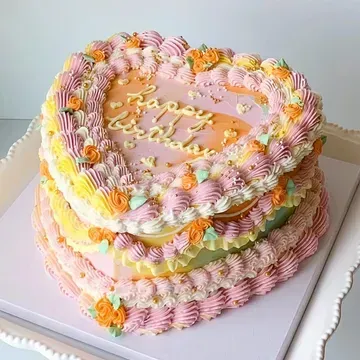 Heart-shaped layered cake with colorful frosting, the words