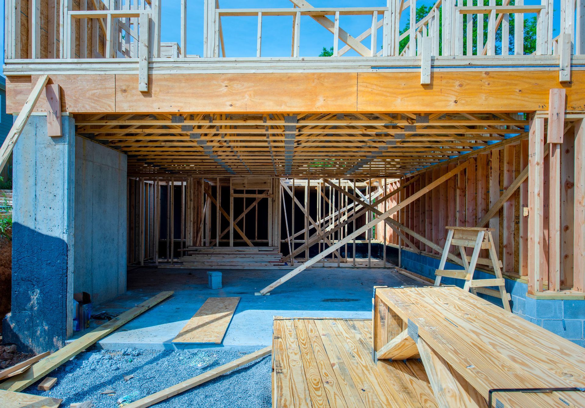 A house is being built with a garage underneath it.