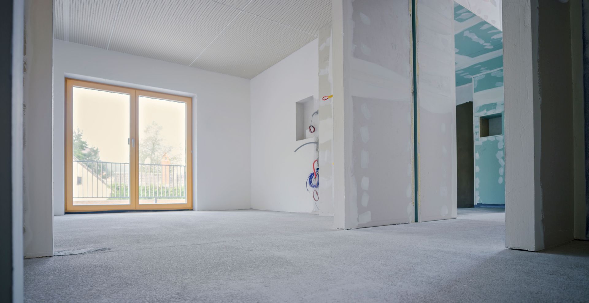 An empty room with a sliding glass door and a window.