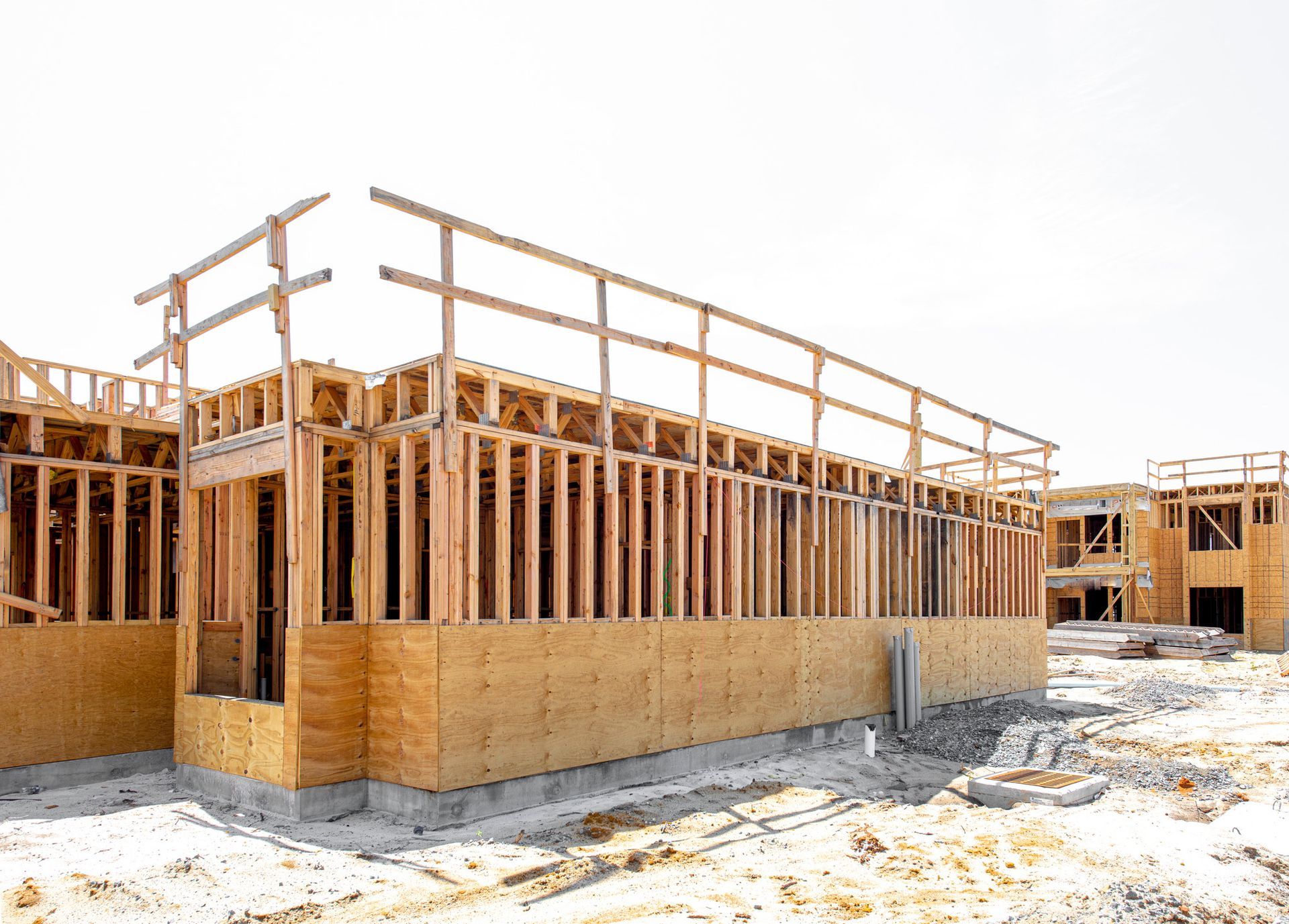A large wooden building is being built on a construction site.