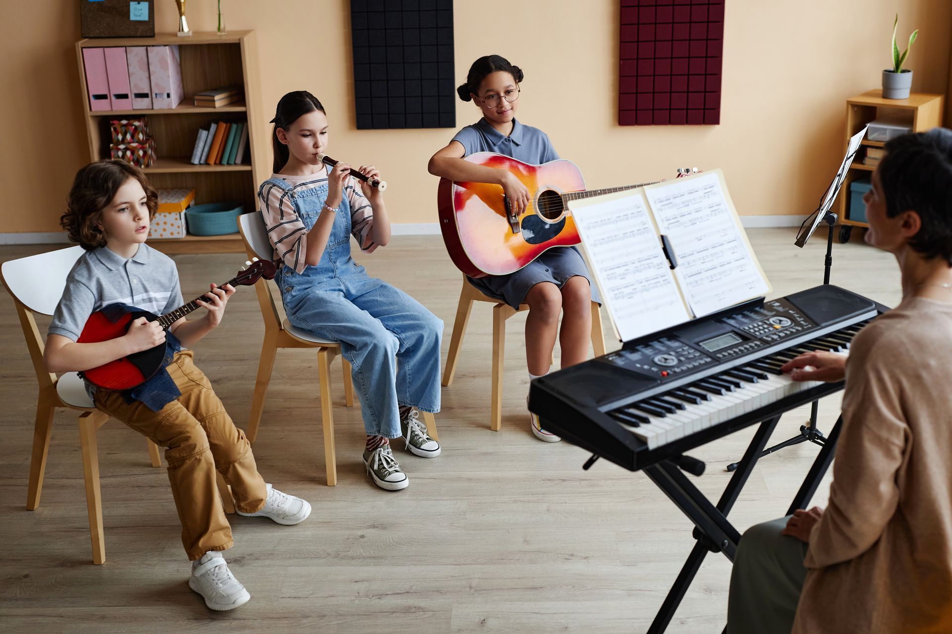 A group of children are playing musical instruments in a classroom.