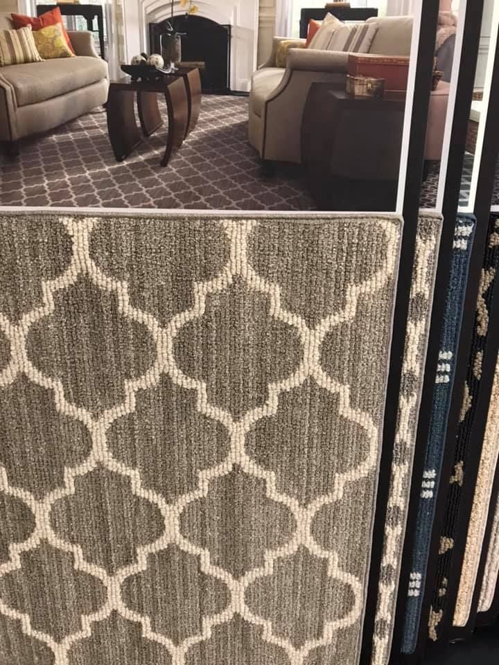 A living room with a rug and a couch