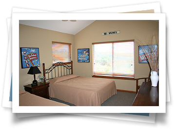 A bedroom with two beds and a sign on the wall that says ' i love you '