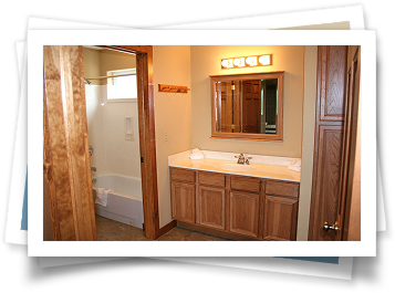 A bathroom with two sinks and a mirror