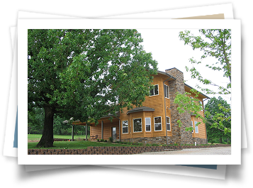 A picture of a house with a tree in front of it