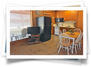 A kitchen with a table and chairs and a refrigerator